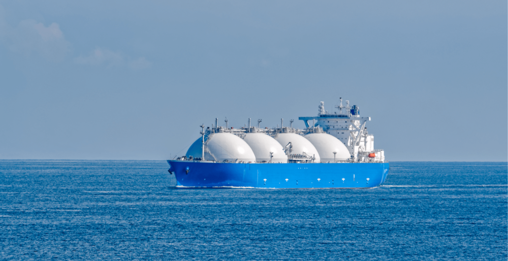 A large alternative fuel LNG carrier on a calm sea, its spherical storage tanks prominently displayed against the horizon.