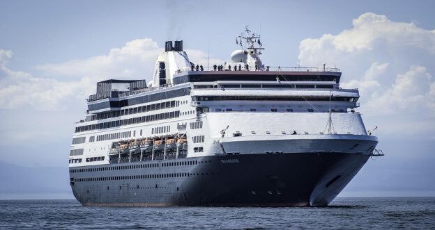 A majestic cruise ship sailing on a vast sea against a backdrop of distant haze, its multiple decks promising adventure and luxury.